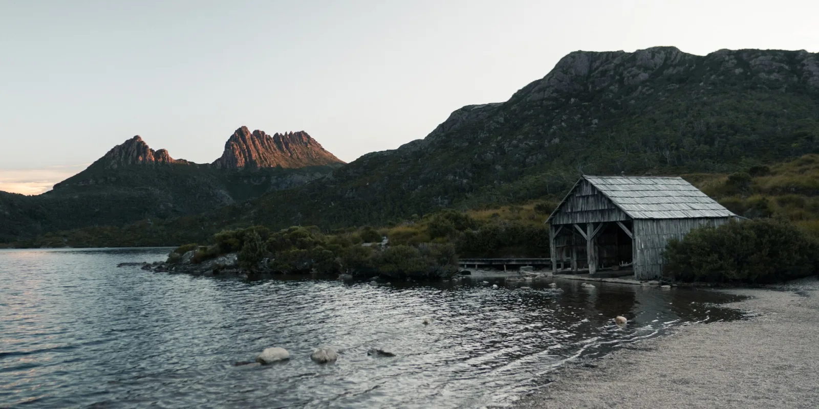 A photo of Cradle Mountain and the boat shed.