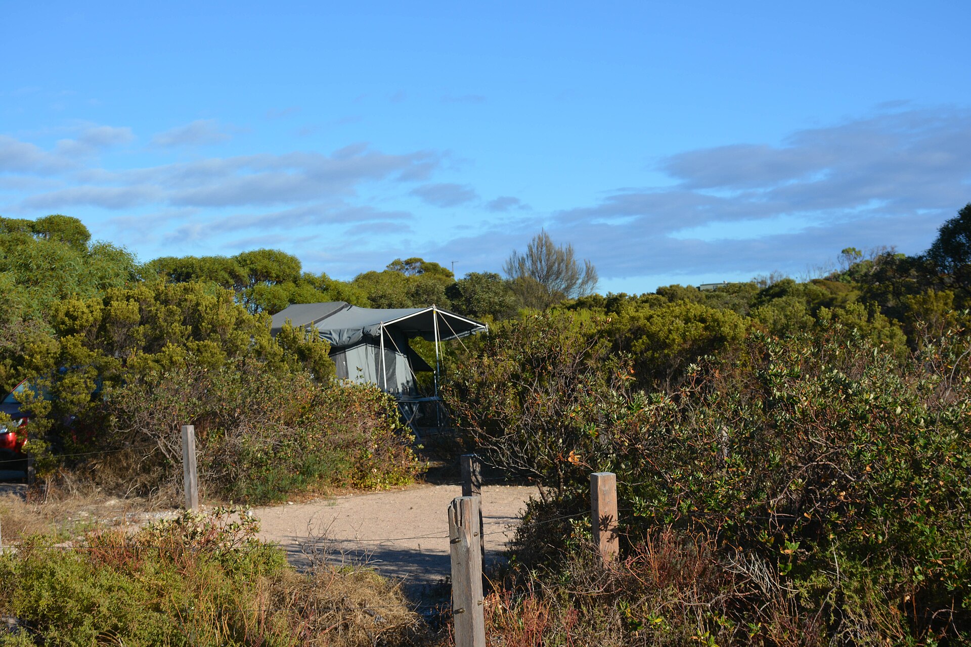 A camper trailer parked among the shrubs in the Pondalowie Bay camping area, at the Innes National Park, Yorke Peninsula, South Australia