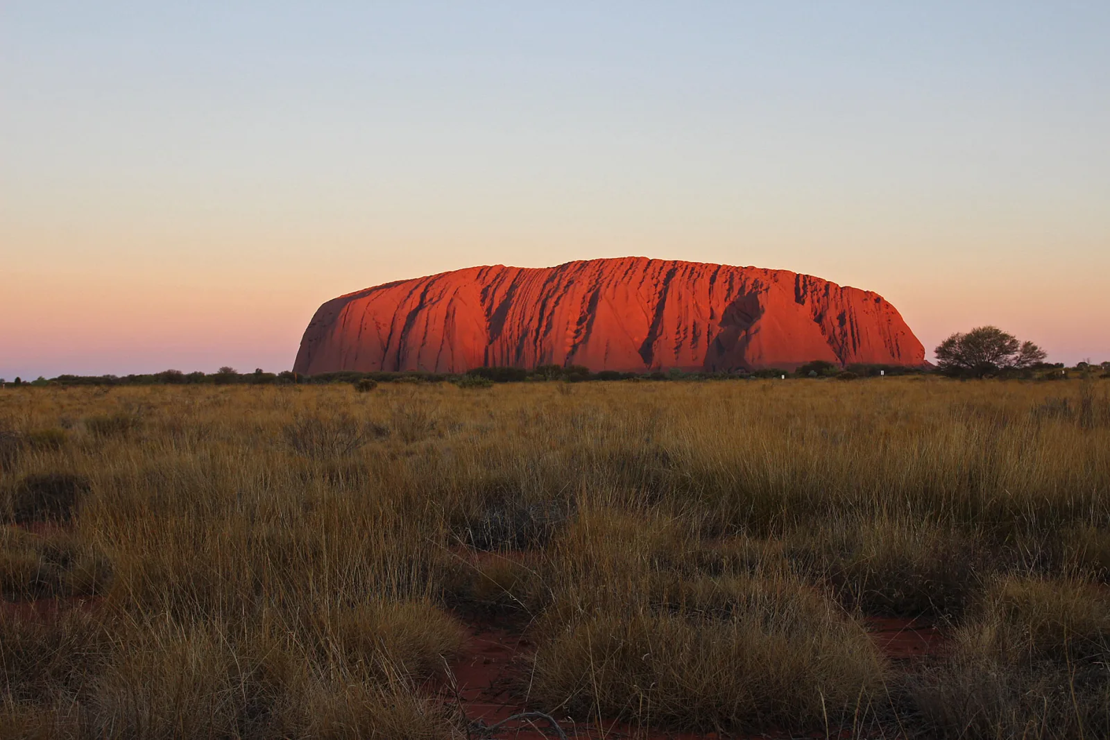 Uluru, or Ayers Rock, is a massive sandstone monolith in the heart of the Northern Territory’s arid "Red Centre". The nearest large town is Alice Springs, 45 km away. Uluru is sacred to indigenous Australians and is thought to have started forming around 550 million years ago. It’s within Uluru-Kata Tjuta National Park, which also includes the 36 red-rock domes of the Kata Tjuta (colloquially “The Olgas”) formation.